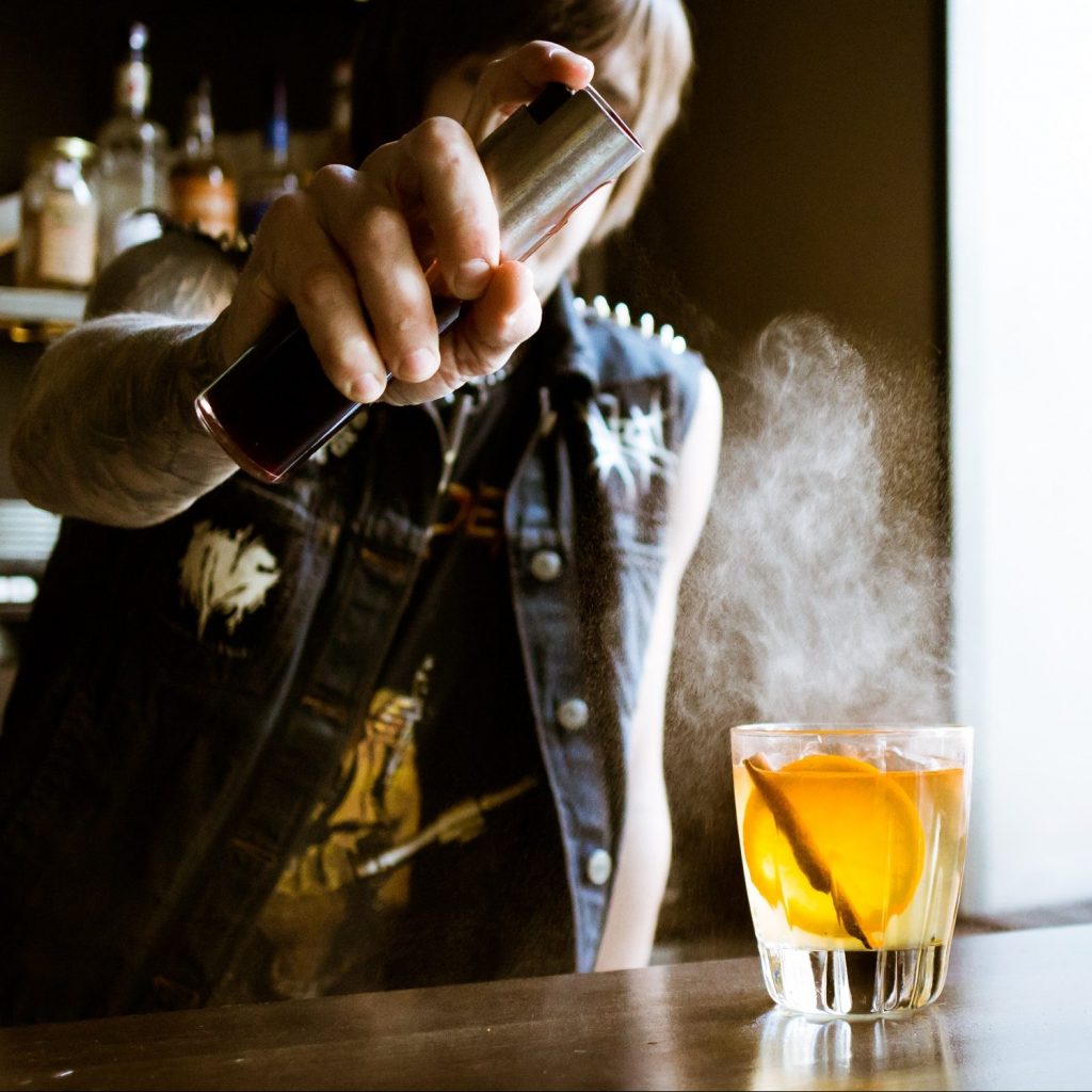 A bartender adds their finishing touches on a signature cocktail.