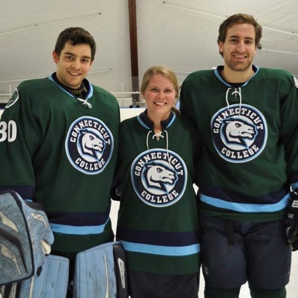 Senior Trainer Darcie Folsom with Connecticut College students supporting Green Dot at a school hockey game.